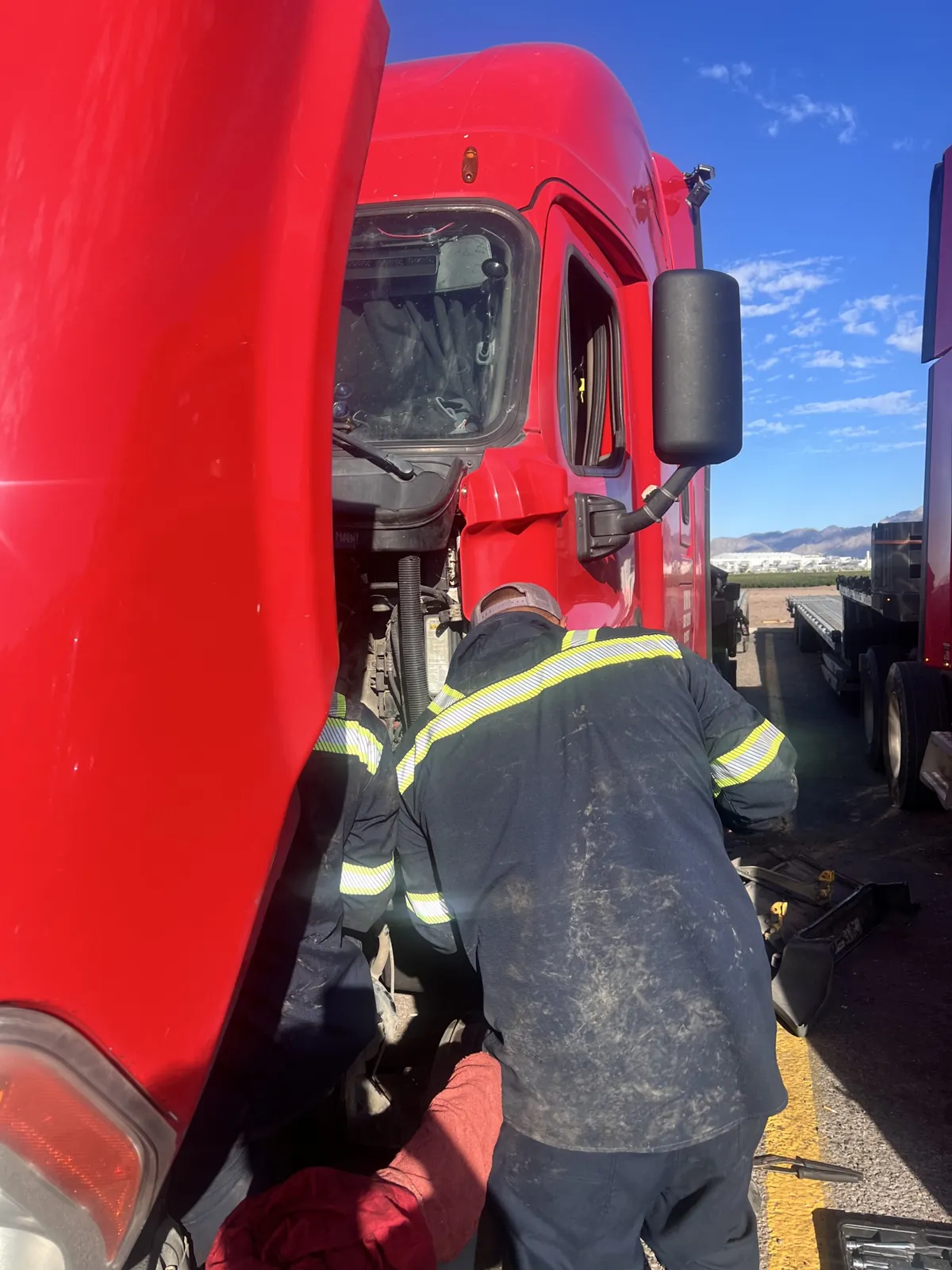 Mobile semi truck repair in Tucson - crew fixing a red semi roadside